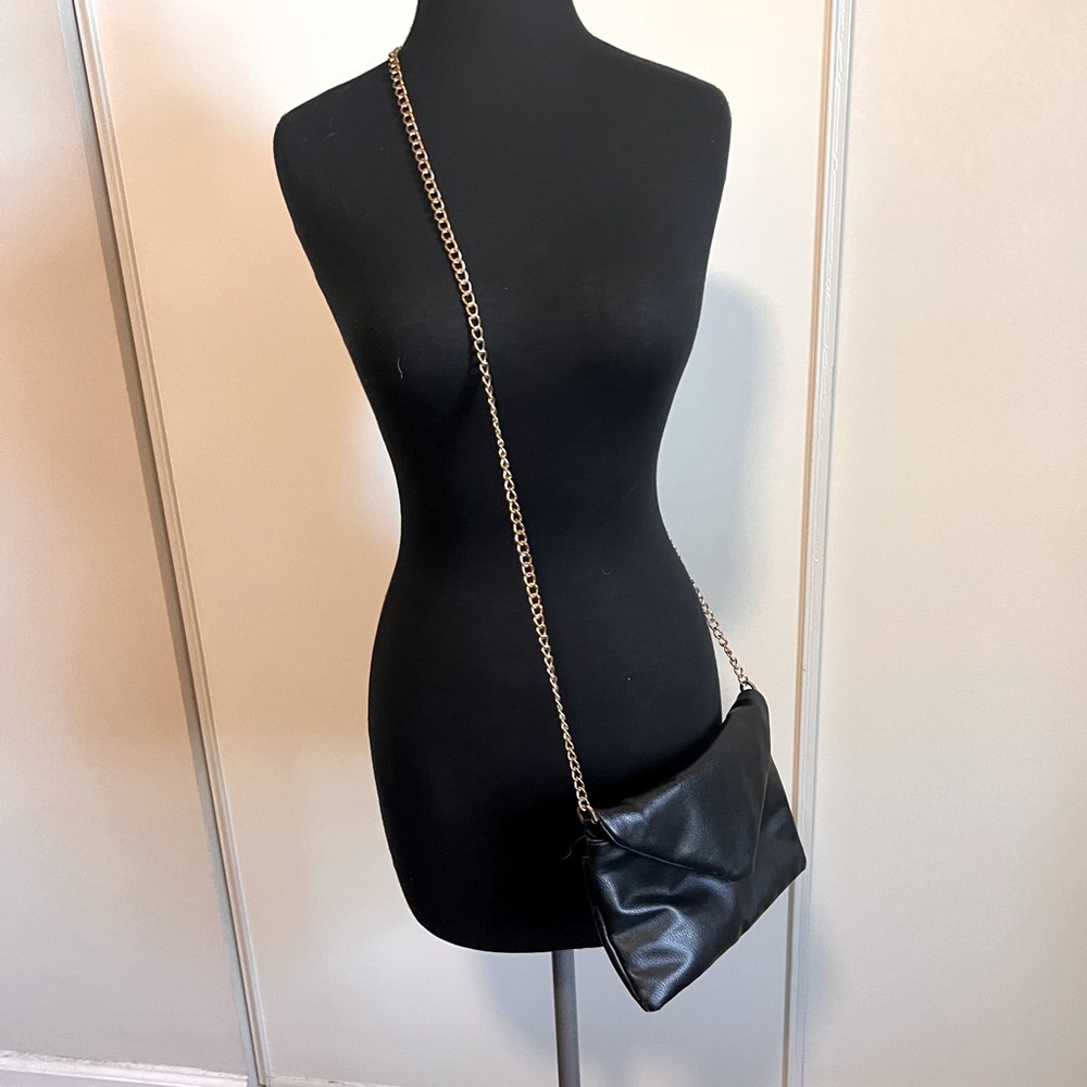A Brand New Day black faux leather purse with gold chain strap. Crossbody.
